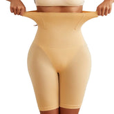 Beige shapewear being stretched by hands against a light background